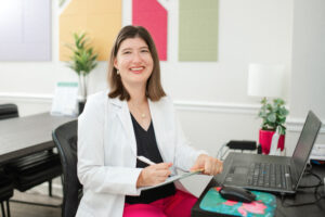 Dr. Amanda Davis at her desk with laptop